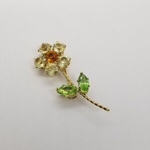 Nolan Miller gold tone rhinestone flower brooch signed